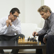 Mid adult men playing chess