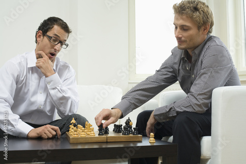 Photo: Mid adult men playing chess Mid adult men playing chess