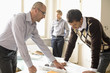 Businessmen looking at blueprint