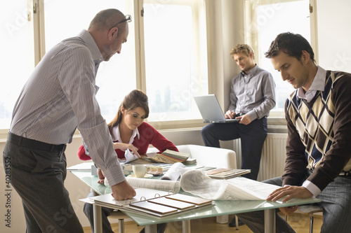 Photo: Business people working in office Business people working in office