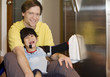 Foto: Father on kitchen floor with disabled son, cleaning the fridge Father on kitchen floor with disabled son, cleaning the fridge