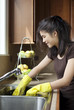 Photo: Teen girl washing dishes at kitchen sink Teen girl washing dishes at kitchen sink