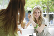 Young woman photographing with mobile phone