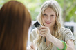 Young woman photographing with mobile phone