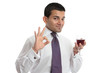 A man with wine shows approval or excellence A man with wine shows approval or excellence