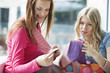 Young women looking at tie