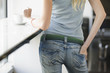 Woman standing by window sill, midsection
