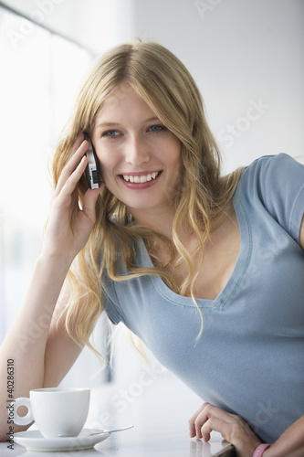 Photo: Young woman using mobile phone Young woman using mobile phone