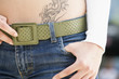 Young woman with tattoo, midsection, close-up