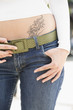Young woman with tattoo, midsection, close-up