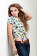 young woman wearing country style clothes near wall