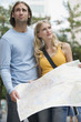 Young couple holding map