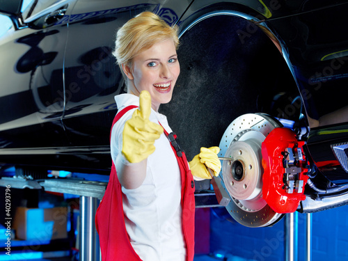 Photo: Apprentice shows thump up after learning to fix a brake Apprentice shows thump up after learning to fix a brake