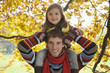 Father carrying daughter on shoulders, smiling