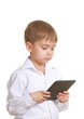 Photo: Reading boy with electronic book. Isolated Reading boy with electronic book. Isolated