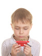 Photo: Cute boy looking on new plant. Isolated Cute boy looking on new plant. Isolated
