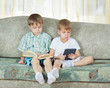 Photo: Two reading boys. With paper and electronic book Two reading boys. With paper and electronic book