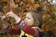 Girl holding branch of tree
