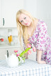 Blond woman leaning on the table