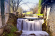 Waterfall between two old buildings
