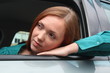 Pretty woman in the car looking outside