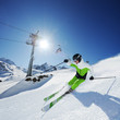 Skier in mountains, prepared piste and sunny day