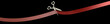 Scissors cut red ribbon closeup. isolated on black