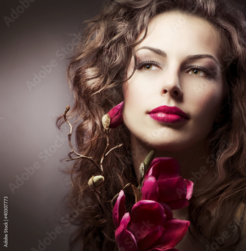 Photo: Fashion Woman With Magnolia Spring Flowers. Sepia Toned Fashion Woman With Magnolia Spring Flowers. Sepia Toned