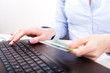 Foto: Business woman with credit card, typing Business woman with credit card, typing