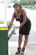 Woman getting a news paper in the city