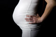 Pregnancy woman on black background