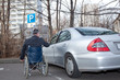 Photo: Mann im Rollstuhl neben Auto Mann im Rollstuhl neben Auto
