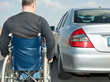Foto: Man in a wheelchair next to his car Man in a wheelchair next to his car