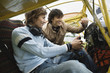 Friends looking at dashboard of airplane