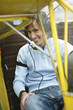 Young man sitting in airplane, portrait