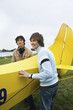 Friends standing by airplane
