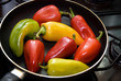Green, yellow and red pepper in frying pan Green, yellow and red pepper in frying pan