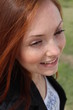Pretty redhead young woman outside