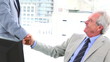 Businessman talking while shaking a hand