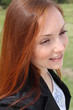 Pretty redhead young woman outside