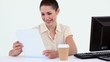 Female worker reading a file at her desk