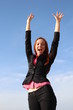 Pretty redhead woman is celebrating with hands up
