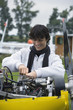 Young man screwing in airplane engine