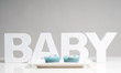 The word baby with two blue cupcakes on a plate The word baby with two blue cupcakes on a plate