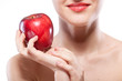Portrait of smiling woman holding red apple isolated on white