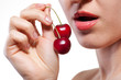 Young woman with cherry isolated on white