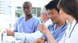 Smiling doctors working together while talking
