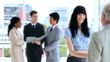 Happy work team standing while talking together