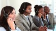 Happy business people using their headsets