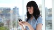 Peaceful businesswoman using her cellphone